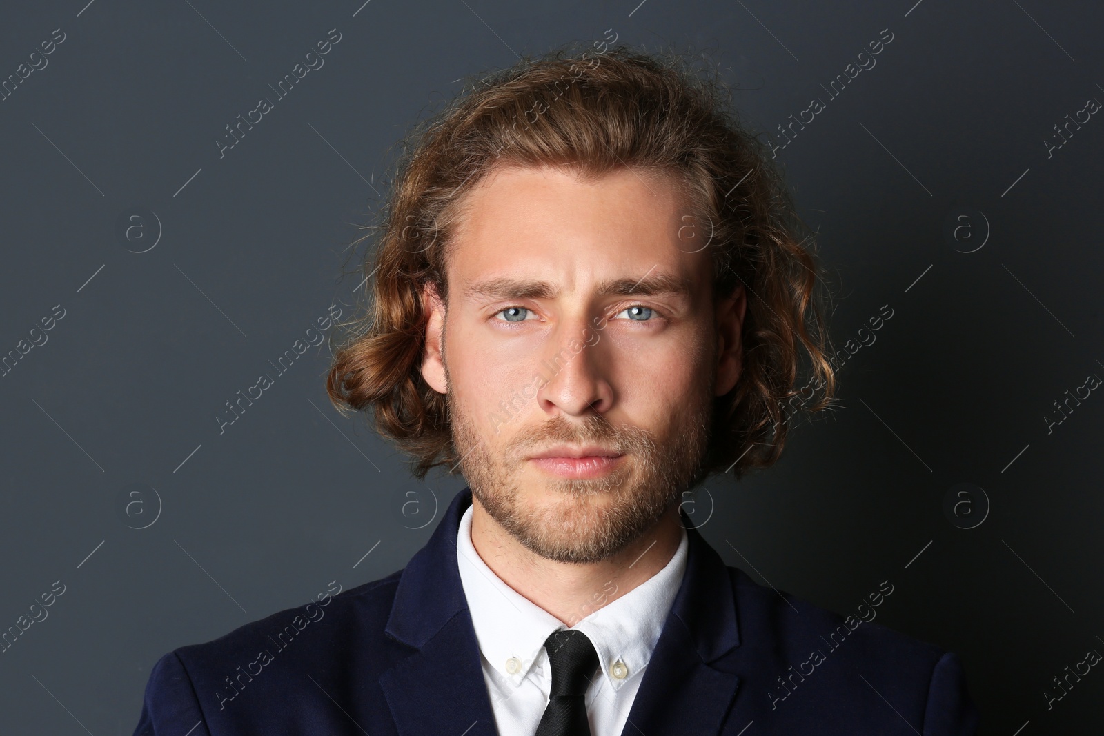 Photo of Portrait of handsome man on dark background