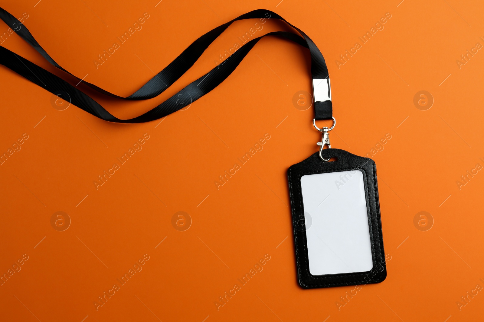 Photo of Blank badge on orange background, top view. Mockup for design