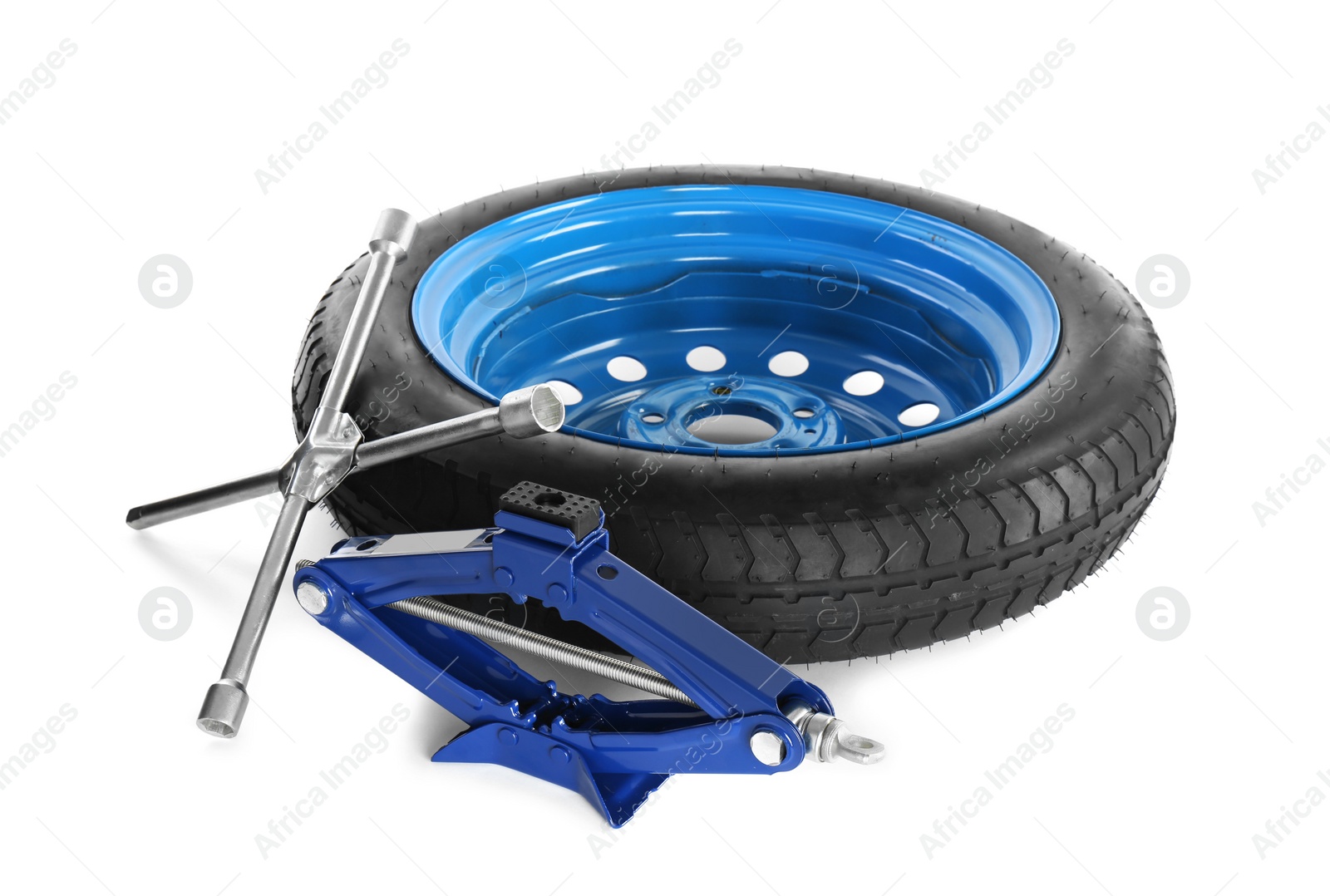 Photo of Car wheel, scissor jack and cross torque wrench on white background