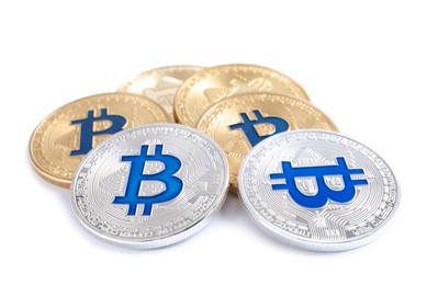 Photo of Pile of bitcoins isolated on white. Digital currency