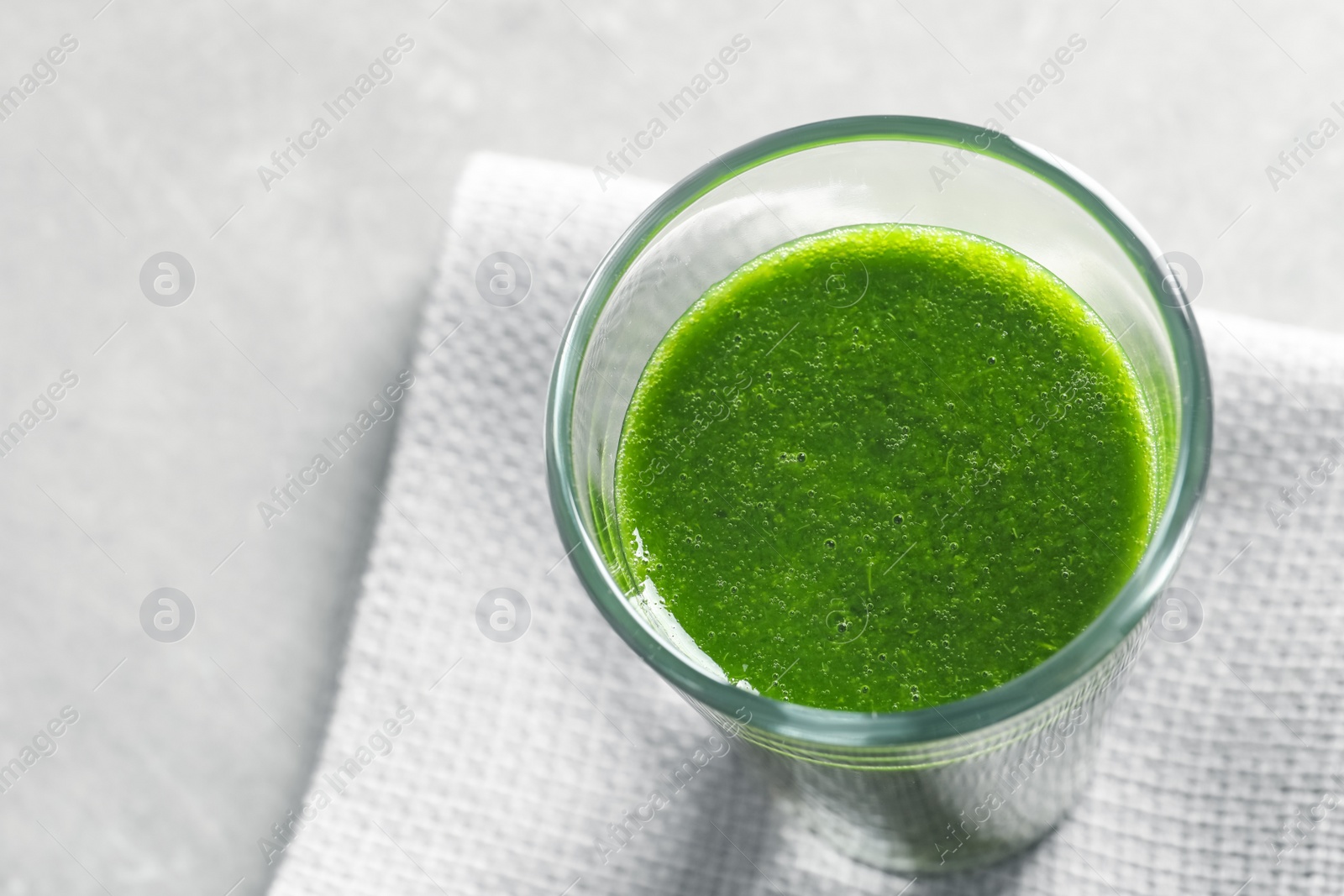 Photo of Glass with delicious detox juice on table, closeup