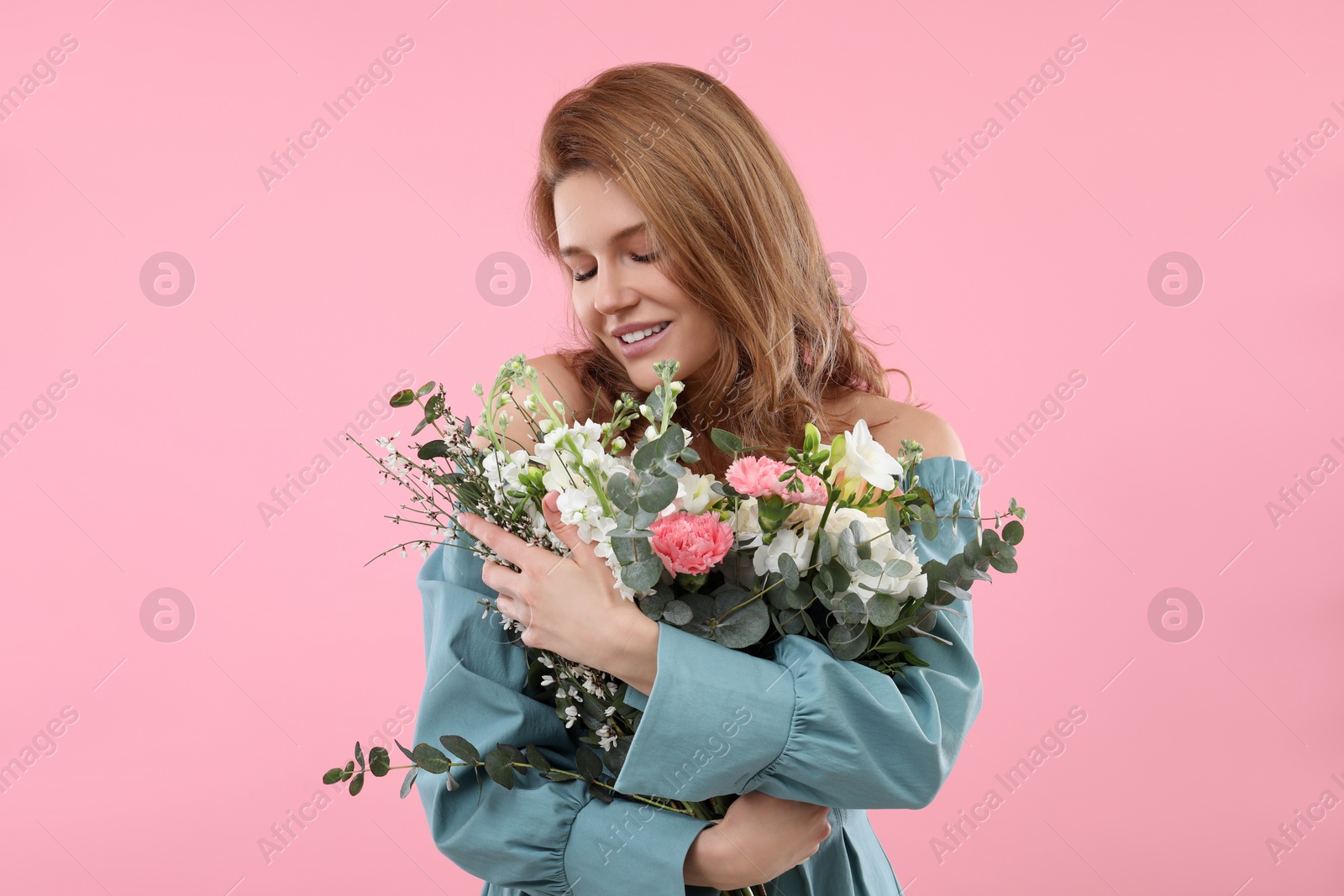 Photo of Beautiful woman with bouquet of flowers on pink background