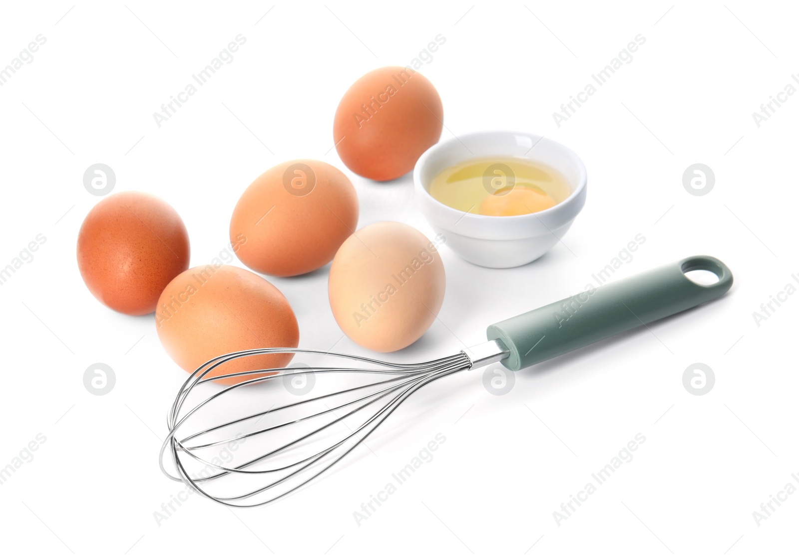 Photo of Whisk, whole and broken eggs isolated on white