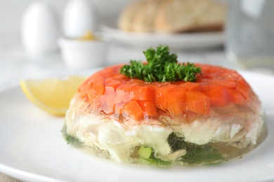 Photo of Delicious fish aspic with parsley on plate, closeup