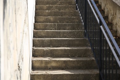 Photo of View of beautiful concrete stairs with metal handrail outdoors