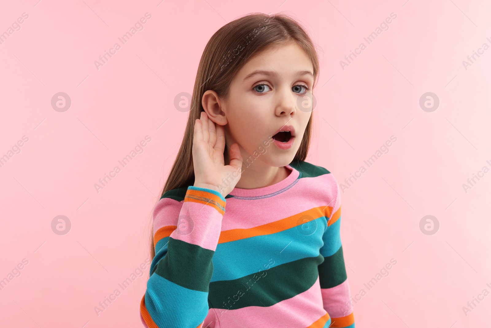 Photo of Little girl with hearing problem on pink background