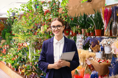 Female business owner with tablet in flower shop