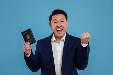 Photo of Immigration. Excited man with passport on light blue background