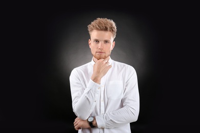 Photo of Portrait of handsome young man on dark background