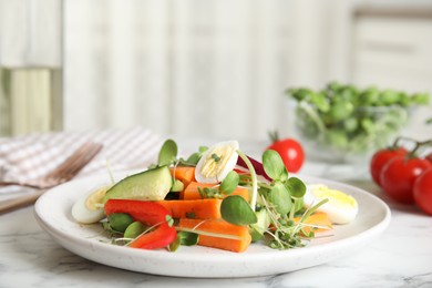 Photo of Salad with fresh organic microgreens in plate on white marble table indoors