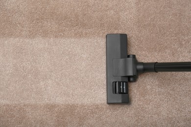 Image of Vacuuming carpet. Clean area after using device, top view