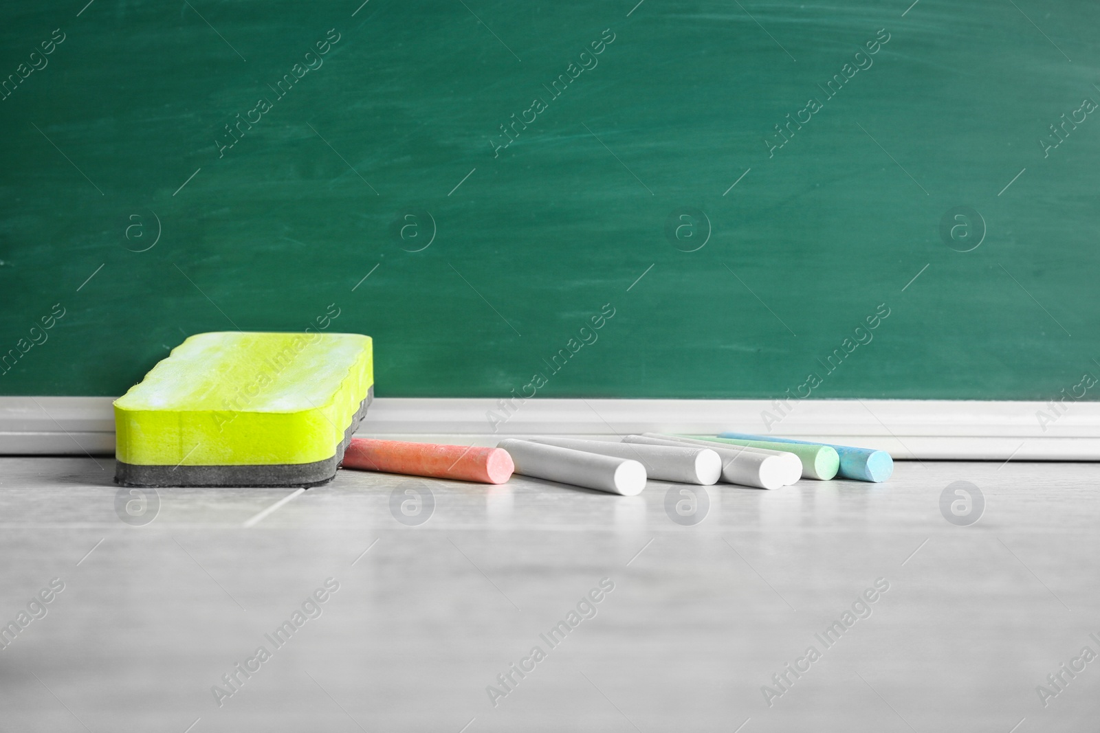 Photo of Chalk and duster on table in classroom