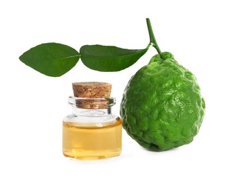 Photo of Bottle of essential oil and fresh bergamot fruit on white background