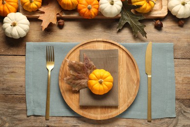 Photo of Autumn table setting, pumpkins and dry leaves, flat lay