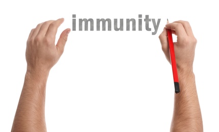 Image of Man writing word Immunity on white background, closeup