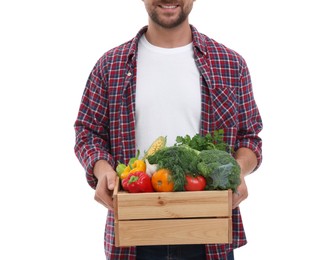 Photo of Harvesting season. Happy farmer holding wooden crate with vegetables on white background, closeup