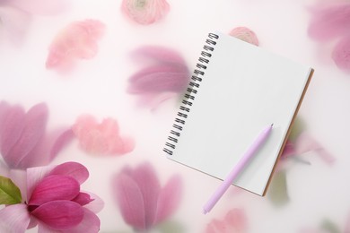 Photo of Guest list. Notebook, pen and magnolia on spring floral background, flat lay. Space for text