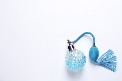 Bottle of perfume on white background, top view