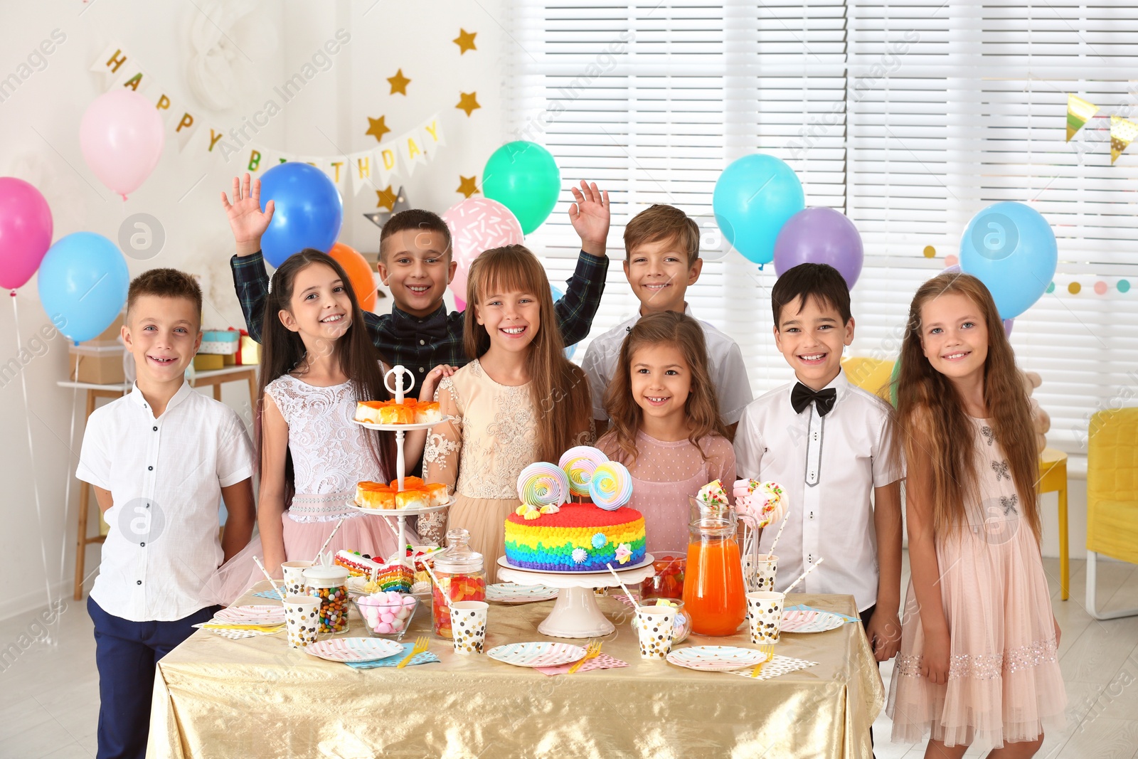 Photo of Happy children at birthday party in decorated room