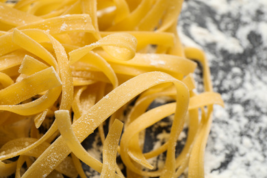 Tagliatelle pasta on grey table, closeup view