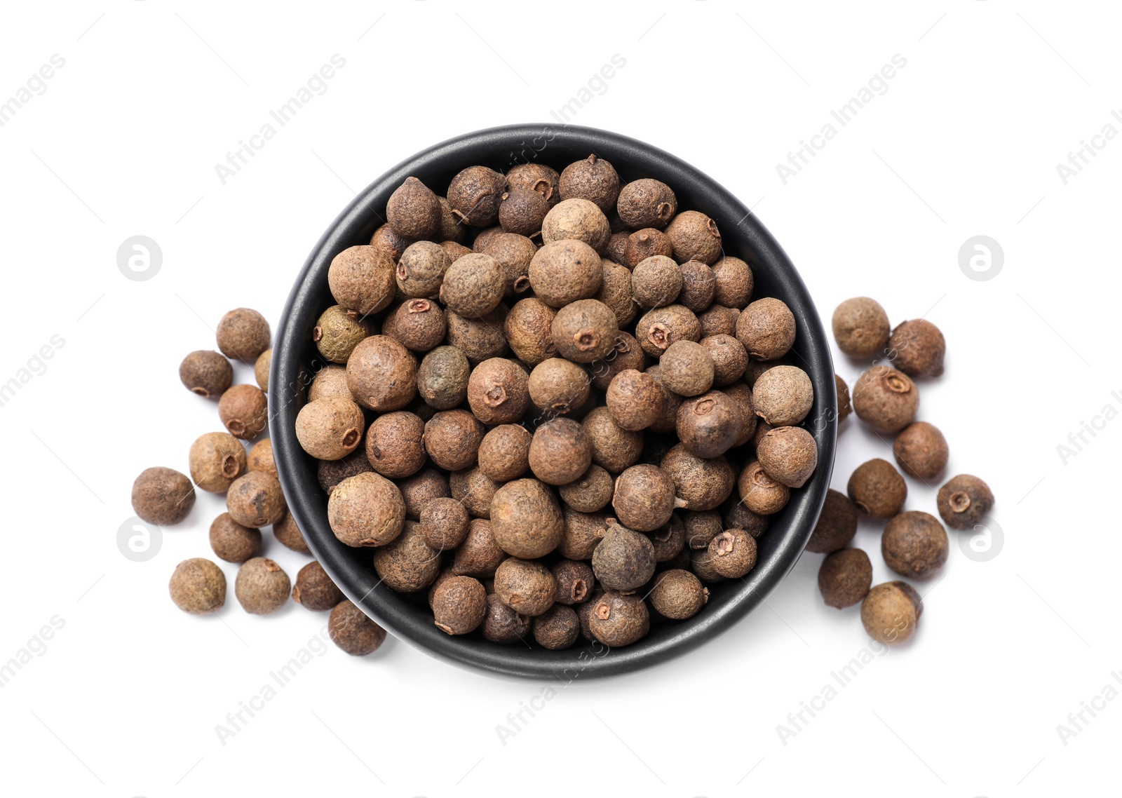 Photo of Dry allspice berries (Jamaica pepper) in bowl isolated on white, top view