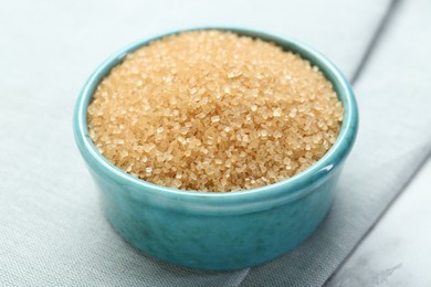 Photo of Brown sugar in bowl on table, closeup