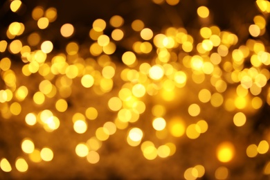 Photo of Gold glitter with bokeh effect on dark background