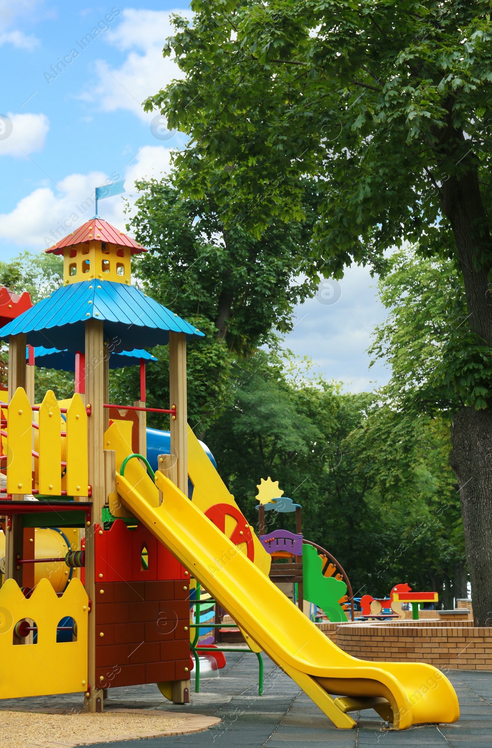 Photo of New colorful castle playhouse with slide on children's playground