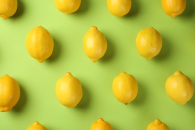 Flat lay composition with fresh ripe lemons on color background