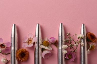 Bullets and beautiful flowers on pink background, flat lay. Space for text