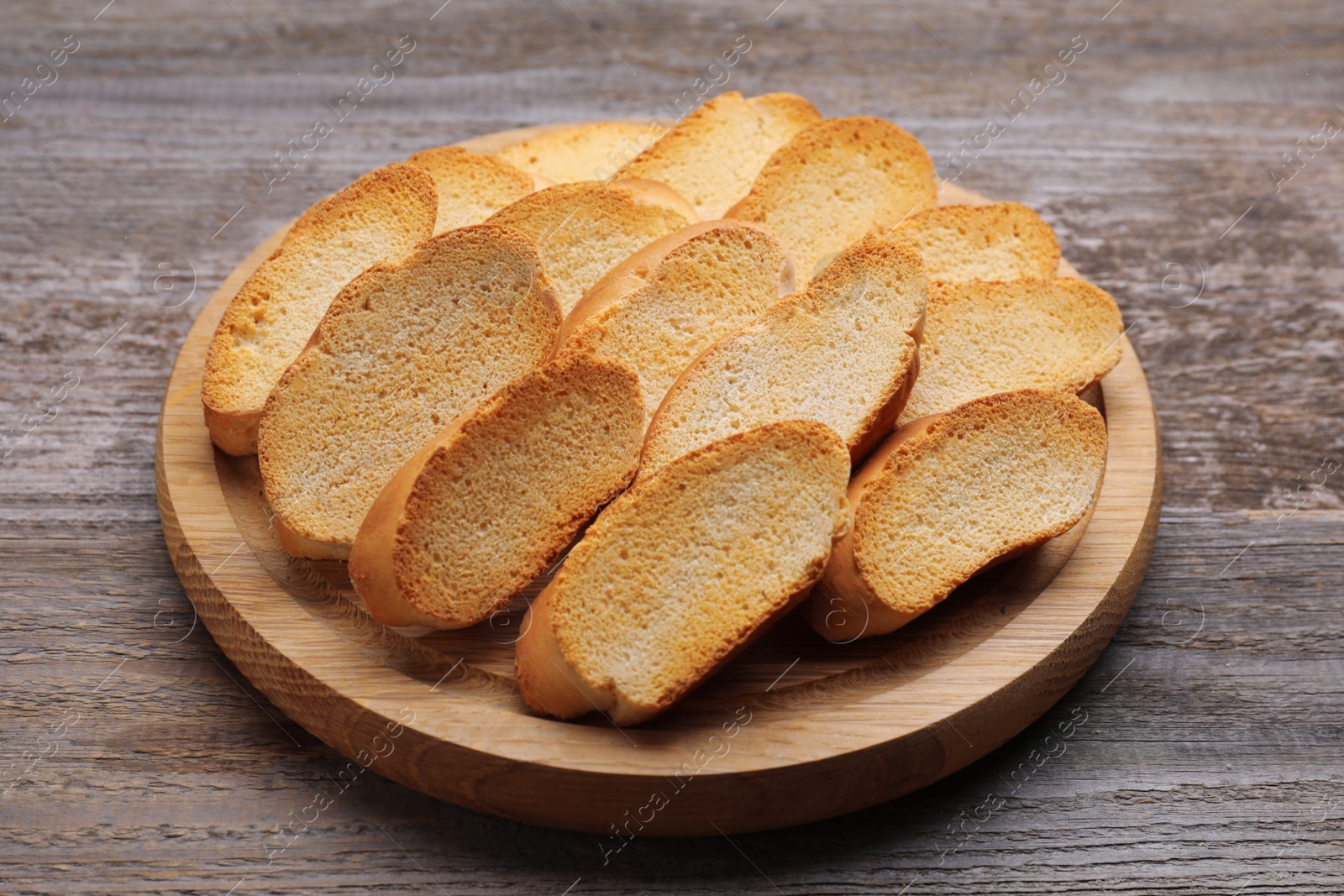 Photo of Tasty hard chuck crackers on wooden table