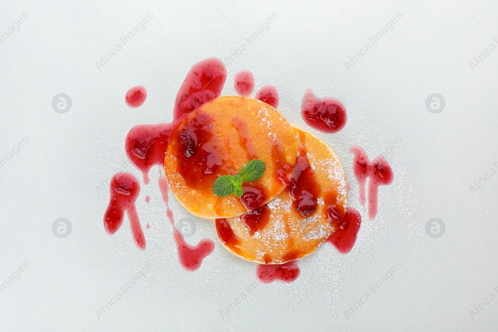 Photo of Delicious pancakes with jam on white background