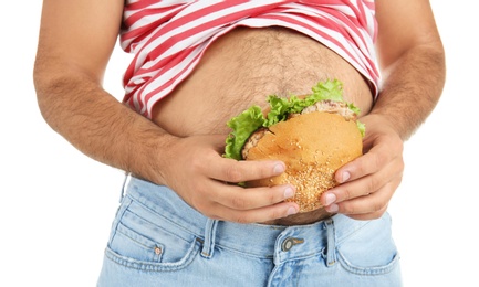 Photo of Overweight man with hamburger on white background, closeup