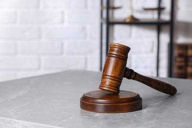 Photo of Law concept. Judge's gavel on light grey marble table indoors, space for text