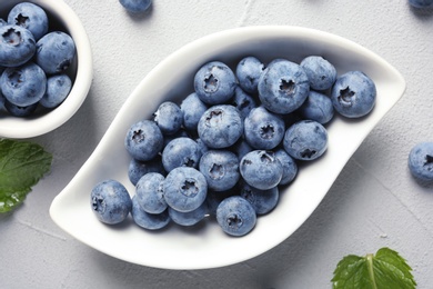 Photo of Flat lay composition with juicy and fresh blueberries on color table