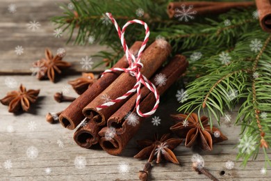 Image of Different spices and fir tree branches on wooden table, closeup. Cinnamon, anise, cloves