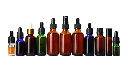 Cosmetic bottles of essential oils on white background