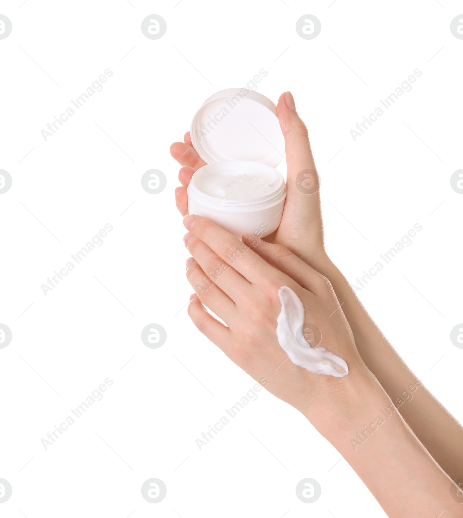 Photo of Young woman applying cream onto her hands on white background, closeup