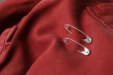 Closeup view of metal safety pins on clothing