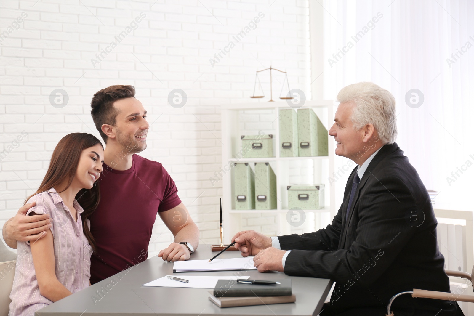 Photo of Lawyer having meeting with young couple in office