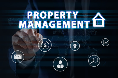 Image of Property management concept. Man using virtual screen with icons, closeup
