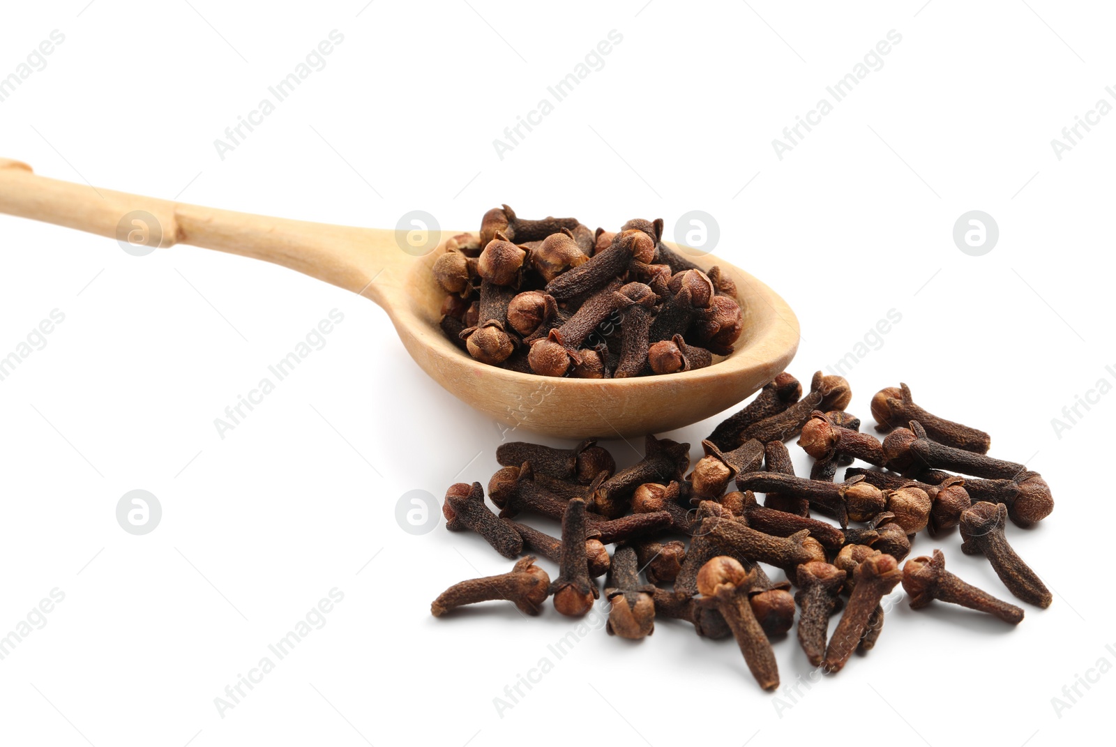 Photo of Pile of aromatic dry cloves and wooden spoon on white background, closeup