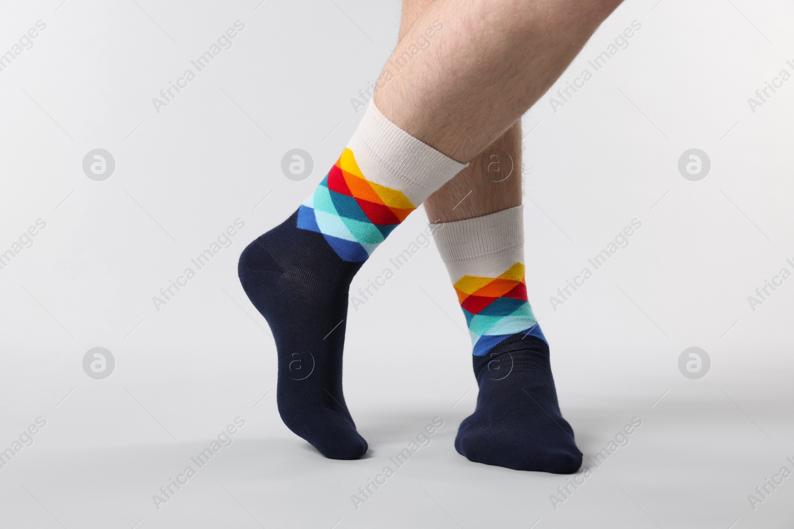 Photo of Man in stylish colorful socks on white background, closeup