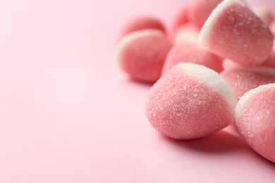 Closeup of sweet jelly candies on pink background. Space for text
