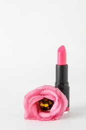 Photo of Beautiful pink lipstick and rose on white background