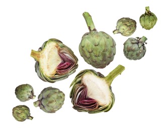 Image of Fresh raw artichokes falling on white background