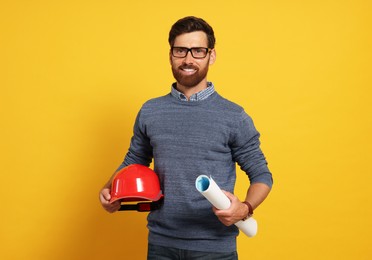 Professional engineer with hard hat and draft on yellow background