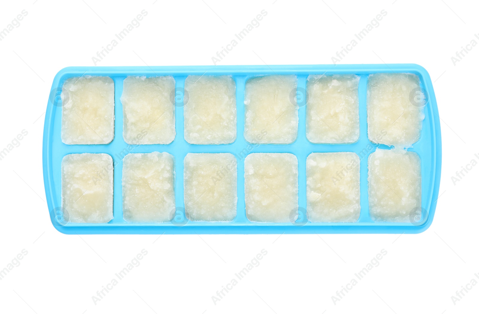 Photo of Cauliflower puree in ice cube tray isolated on white, top view