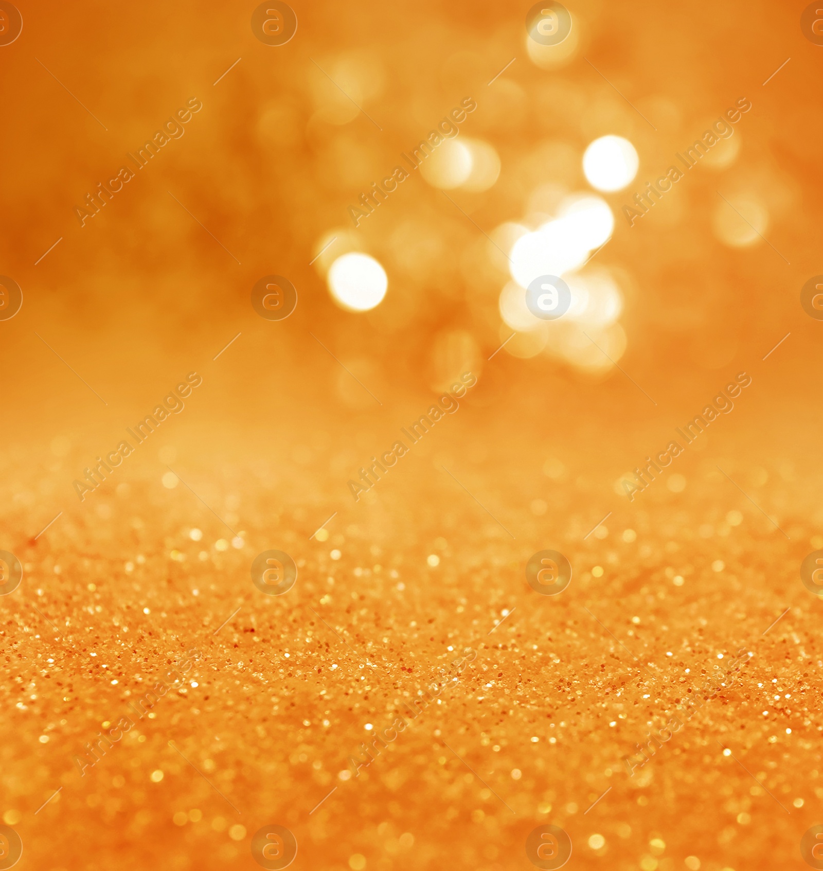 Image of Shiny orange glitter and blurred lights on background. Bokeh effect