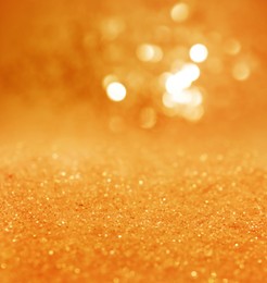 Image of Shiny orange glitter and blurred lights on background. Bokeh effect